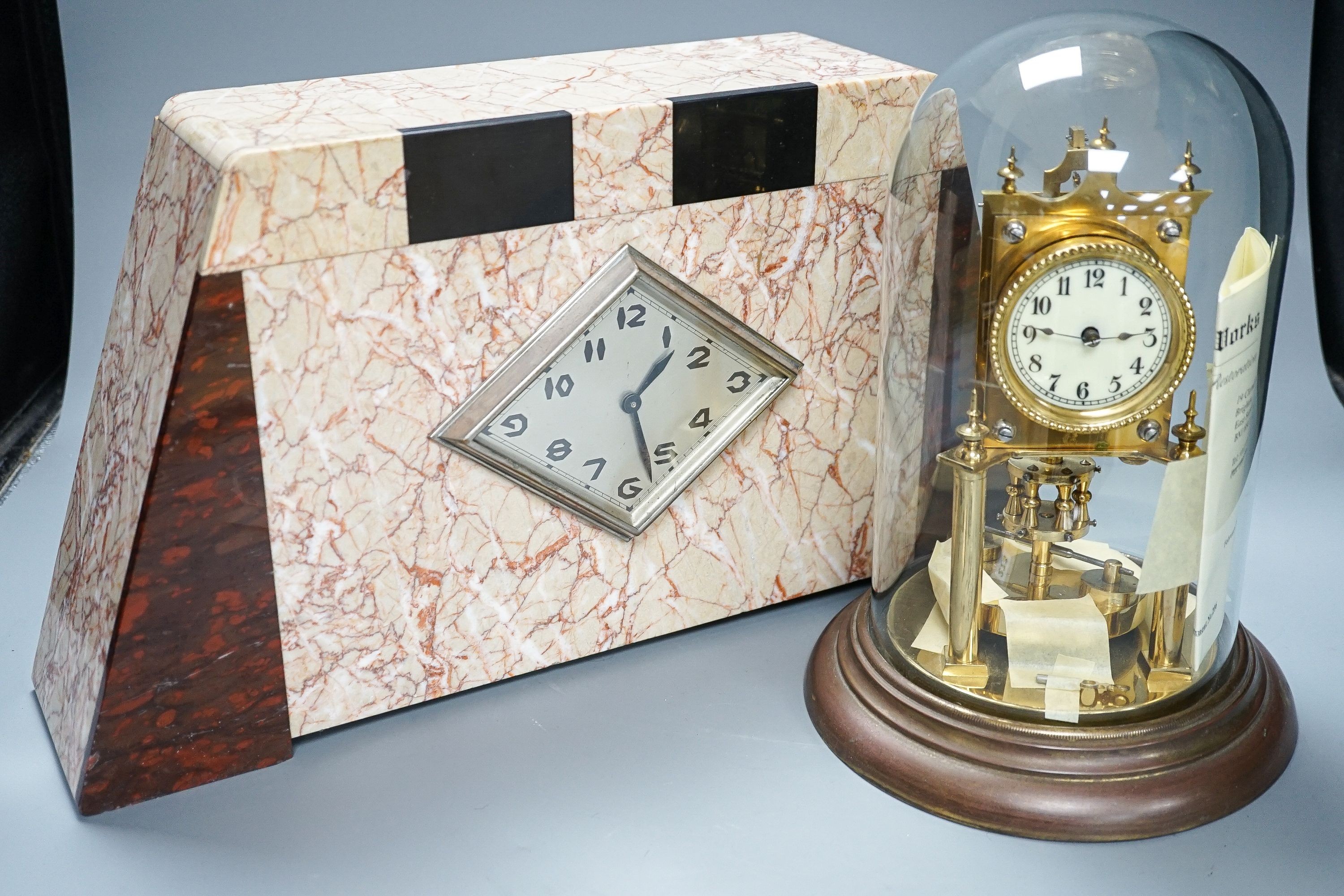 An Art Deco rouge marble mantel timepiece, 45cm wide, quartz movement replacement and a brass anniversary clock under glass dome